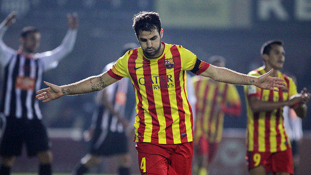 Cesc Fàbregas running and opening his arms to celebrate a goal